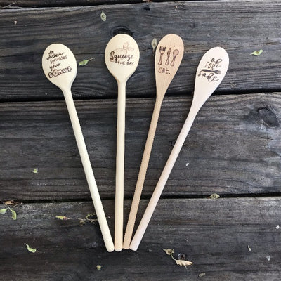 Wood Cooking Spoon Set.  Includes four spoons with different wood burned designs:  1. Do whatever sprinkles your donut, 2.  Squeeze the day with a lemon, 3. Eat with a fork, knife, and spoon, then 4. Oh for fork sake.  Fun kitchen housewarming gifts.