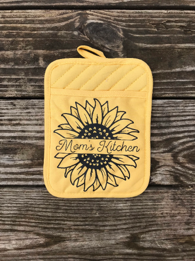 This yellow pocket pot holder has a split sunflower with the quote Mom's Kitchen in between.  A useful and cute mother's day gift for those who like to cook or bake.