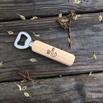 Stainless Steel Bottle Opener with Wooden Handle.  Handle has the word "wild" with a pine tree as the letter i that is wood burned by hand.  Great bottle opener to keep in your kitchen or take on the go.  Beer Lover Gifts.