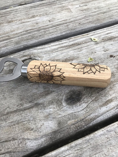 Stainless Steel and Wood Bottle Opener.  Wooden handle has wood burned sunflowers.  Great kitchen and beer lover gifts.