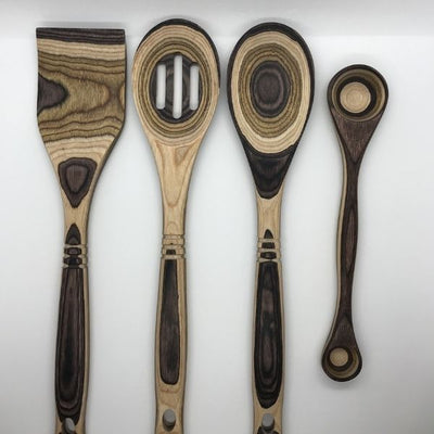 Brown Pakka Wood Utensil Set.  Includes wooden spatula, wood cooking spoon, wood slotted spoon, and a double sided measuring spoon.  Measuring spoon has 1 tablespoon and 1 teaspoon measurements.  This utensil set is an excellent kitchen gift