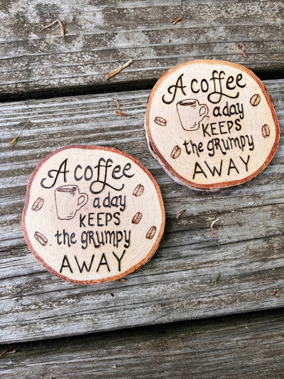 Birch wood slice coffee coaster with wood burned designs of the quote "a coffee a day will keep the grumpy away".  Great gift for coffee drinkers.