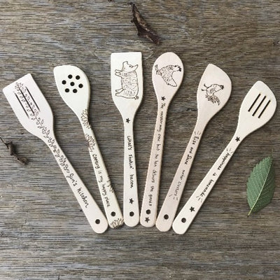 6 piece wood utensil set.  Set includes 4 different types of spoons and 2 spatulas, each with wood burned designs (leaves/vines, sunflowers, pig, chicken, rooster, and quote "happiness is homemade".  All wood burned by hand.