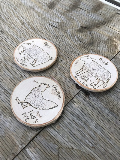 Set of three kitchen magnets that have meat cooking temperatures and butcher cuts.  One chicken, cow, and pig wood slice magnets.