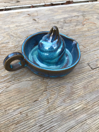 Handmade Blue Pottery Juicer.  Put the fruit on top then twist and squeeze to get juice out of the fruit.  Then pour out of the spout into a cup.  Useful for making homemade lemonade or orange juice!