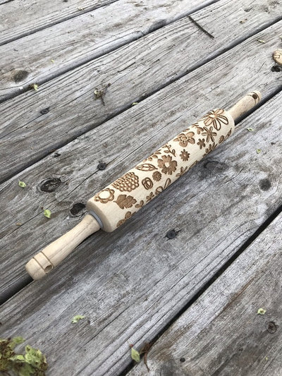 Wood Rolling Pin with Flower Designs.  Make cookies with flower designs in them.